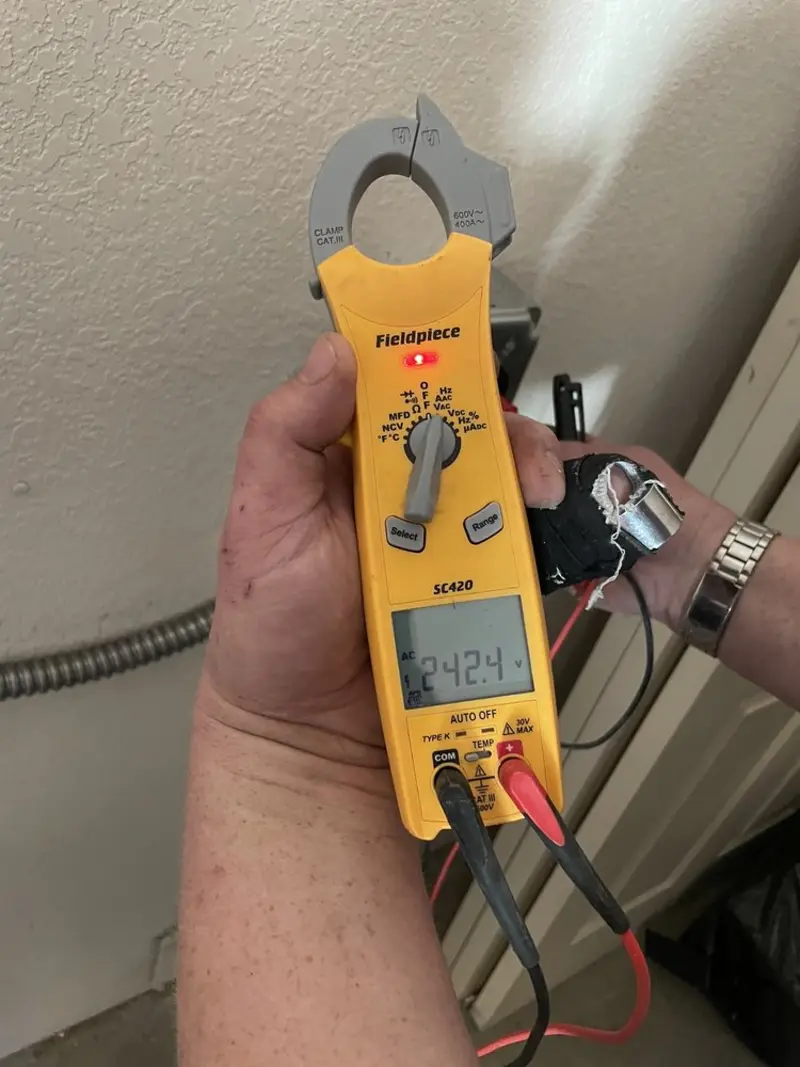 Voltage testing with clamp meter during Electrical Installation Services in Nappanee